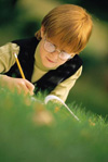 Boy writing outside