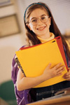 Young girl holding notebooks