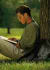 Boy reading outside