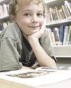 Boy reading in library