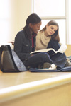 Teenage girls studying on bench