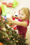 Girl decorating Christmas tree
