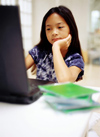 Girl with book and computer