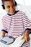 Boy with headphones, cd player, and book