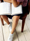 Student with book on lap /></td>
<td width=