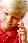 Boy with pencil thinking