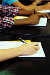 Students writing in classroom