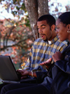 Man and woman working on laptop