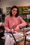 Female teacher sitting in empty classroom