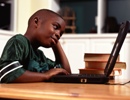 Boy doing homework on computer