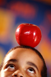 Boy balancing apple on head