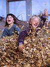 Students jumping in leaves