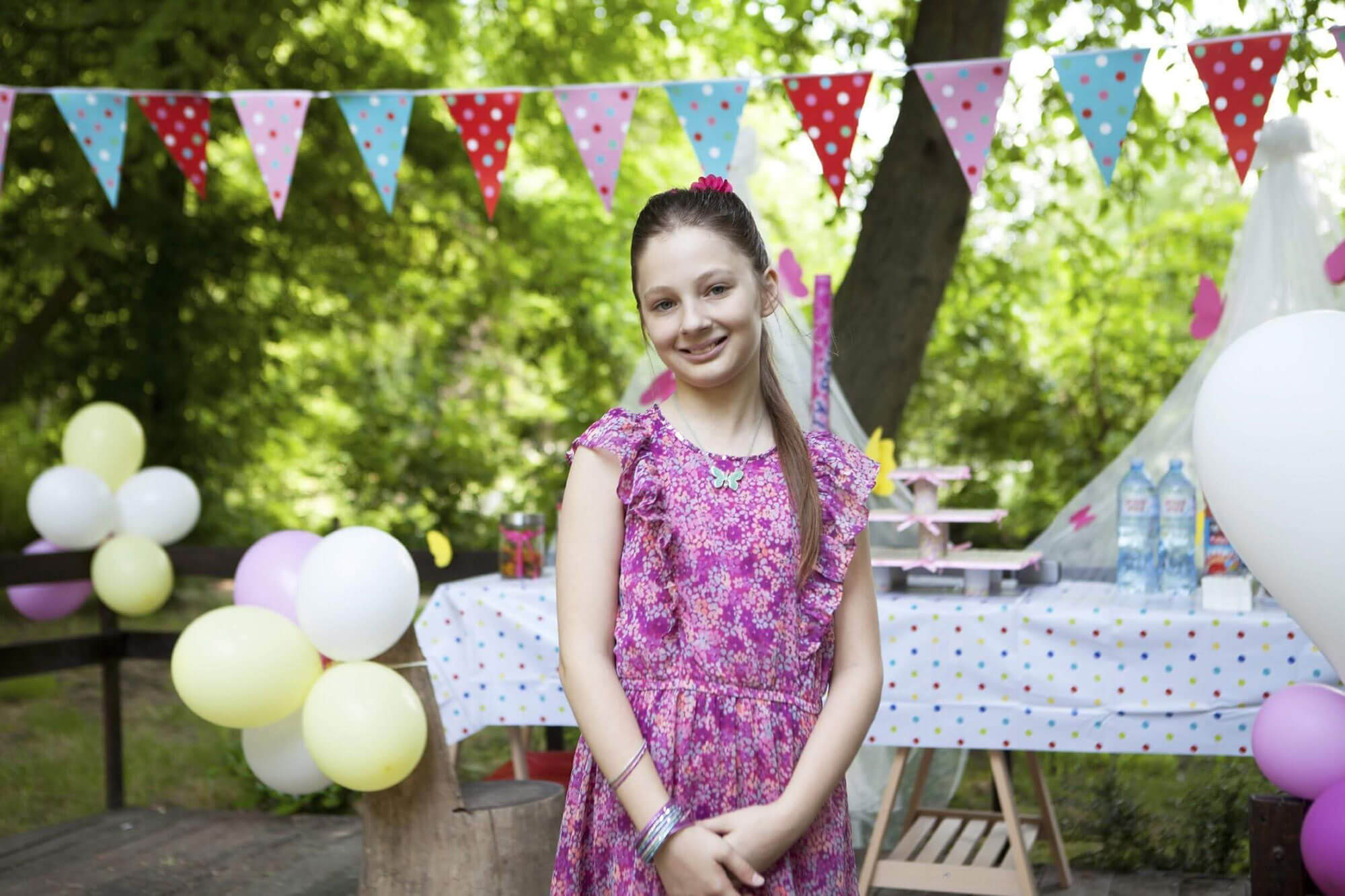 Smiling Girl Standing Outside at Birthday Party