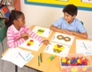 Boy and girl working with attribute blocks