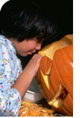 Girl making jack o'lantern for Halloween