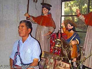 Don Juan de la Cruz Rosales, a Cakchiquel Maya elder from Panajachel, poses with the saints that he cares for as part of his responsibility to his Cofradía.