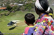 Wide-eyed townspeople look on as Harris Whitbeck's helicopter lands in the ancient plaza outside of San Mateo.