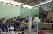 Harris Whitbeck talks to Mateo Alonso. The other men at the meeting are representatives from San Mateo Ixtatan and its surrounding villages.