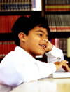 Young male student using laptop in library