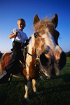 Boy horseback riding