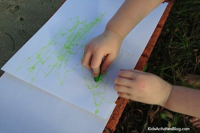 Child Creating Nature Art with Crayon