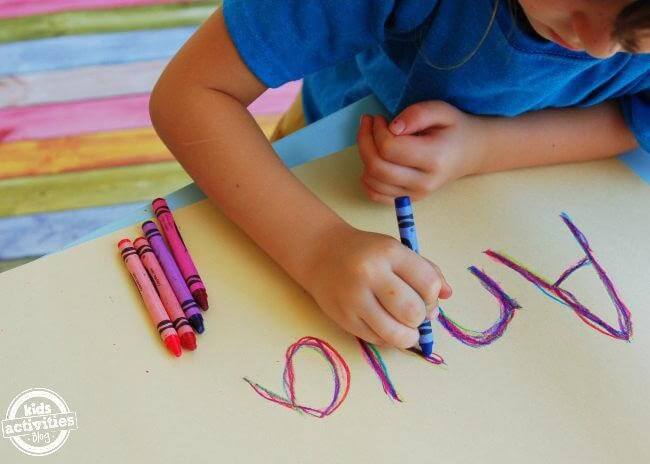 Young Boy Writing Letters with Crayon