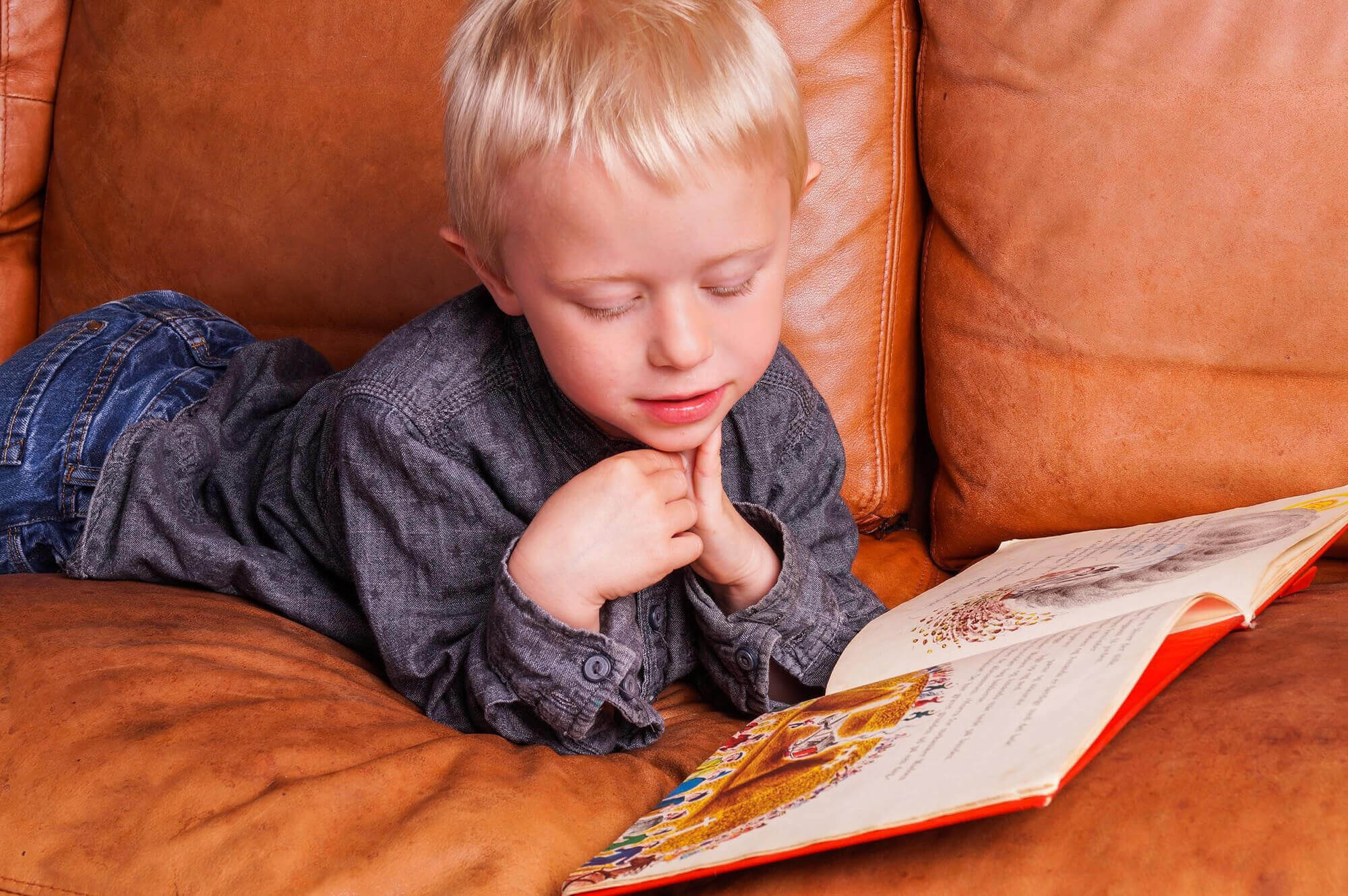 Young Boy Reading on Couch