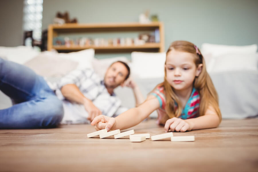 girl playing with dominoes STEM activity