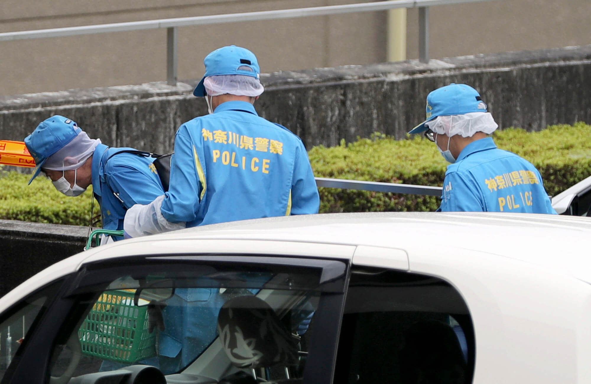 Image of doctors walking around the scene of the shooting