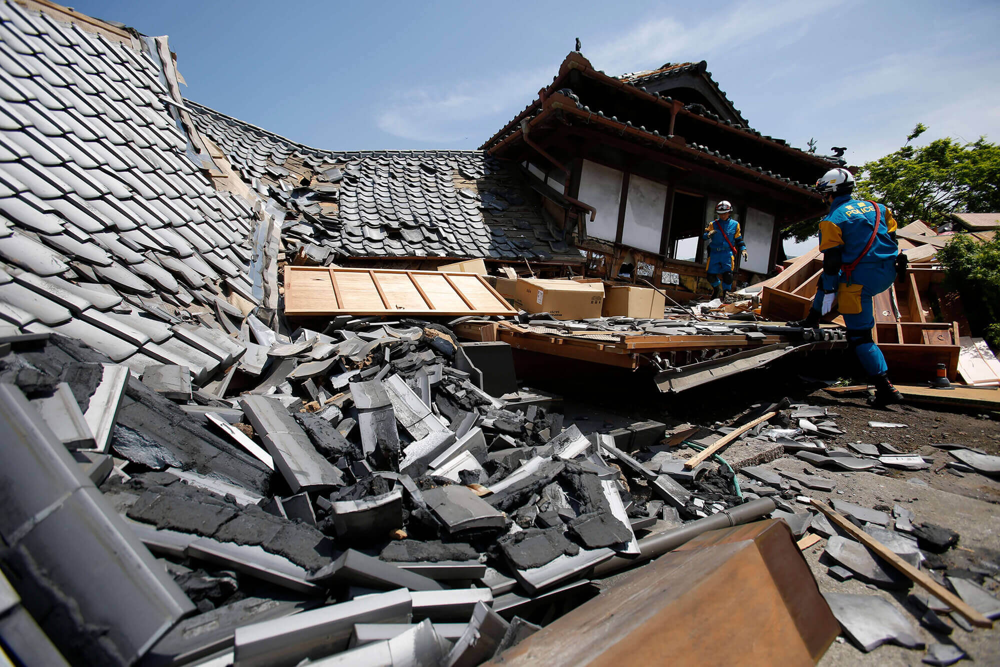 Police rescue team members search for survivors of Japan's earthquake