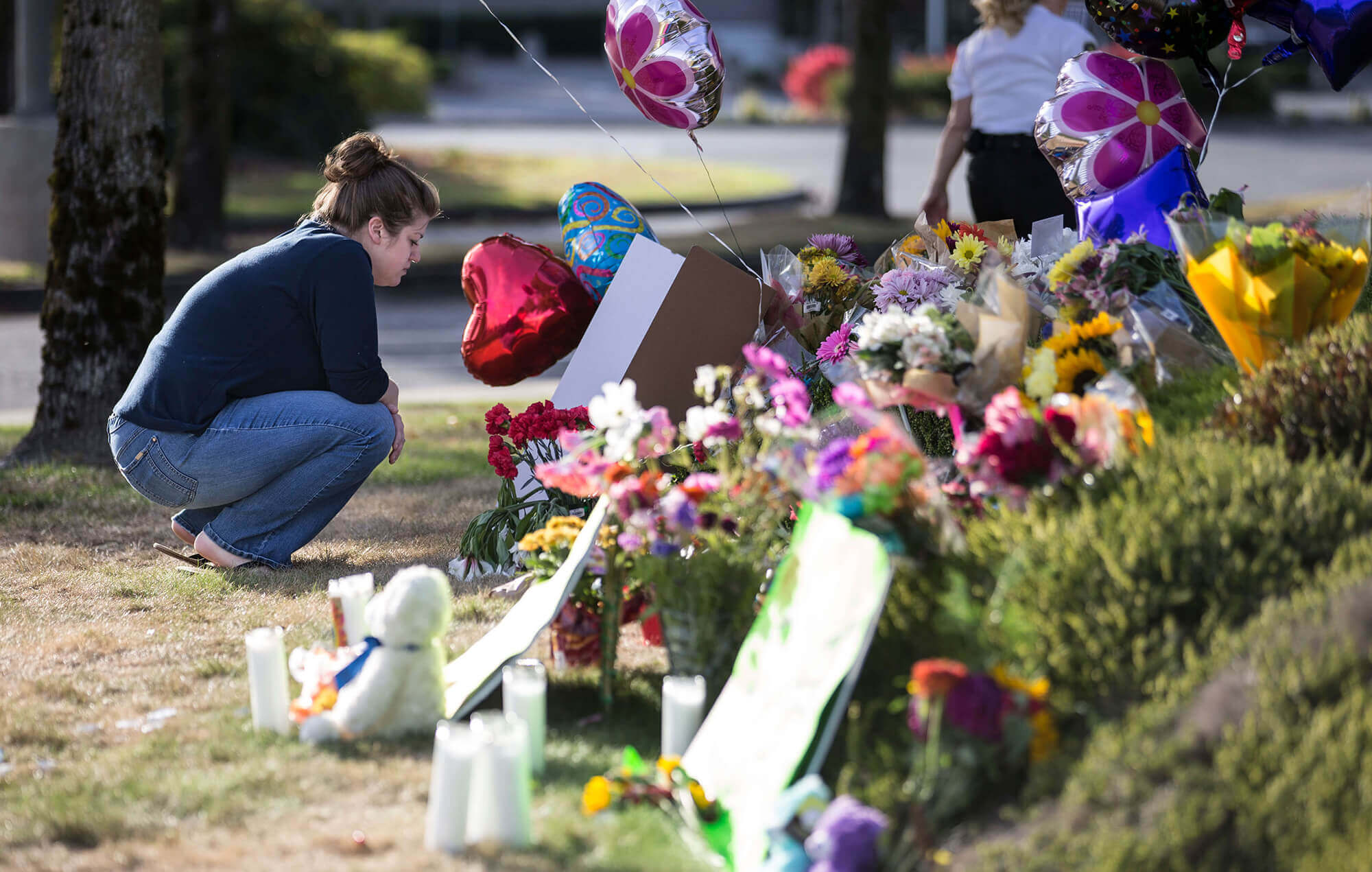 Image of flowers and signs as a memorial to the vicitms of the shooting