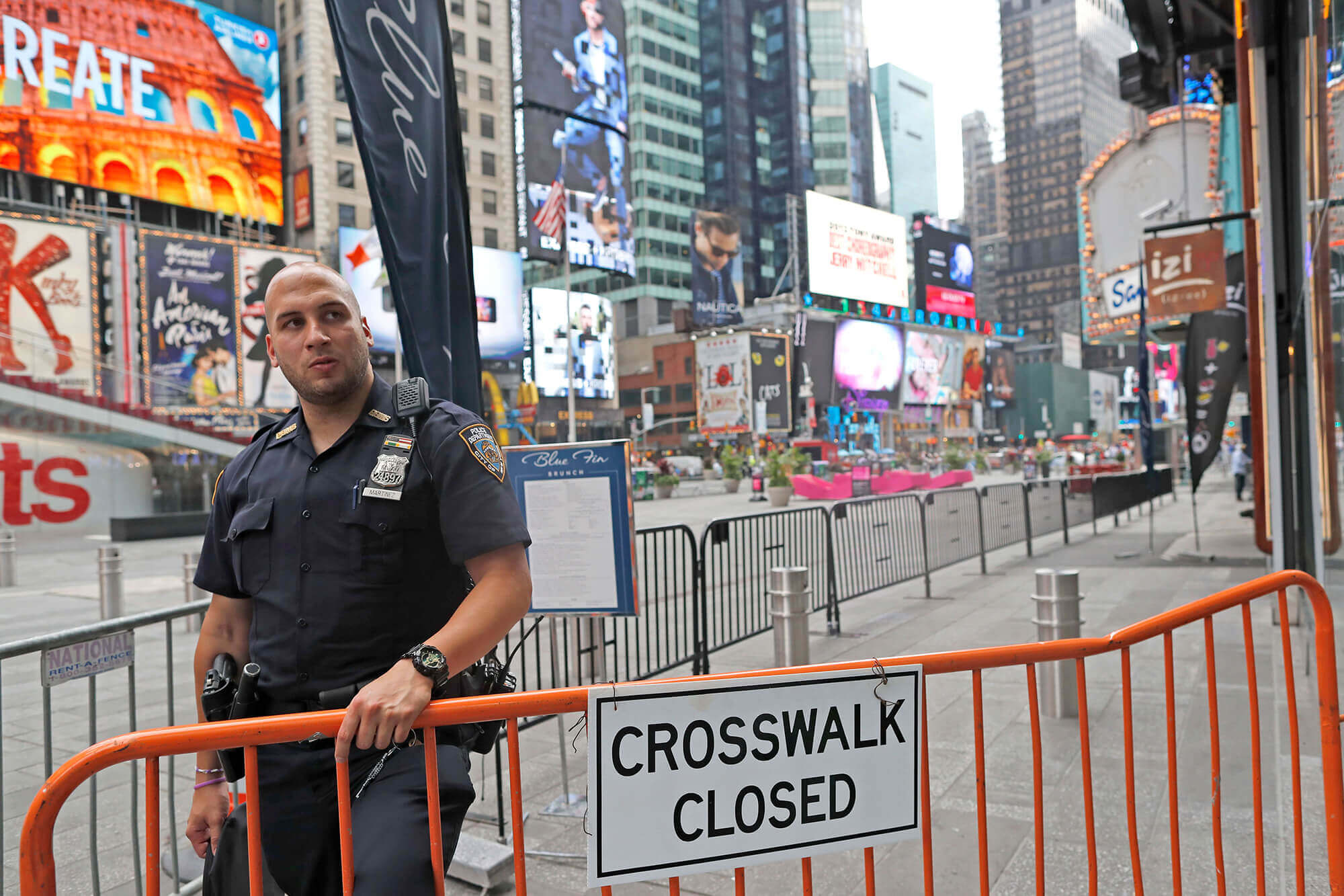 Image of police officer blocking off Times Square to pedestrians