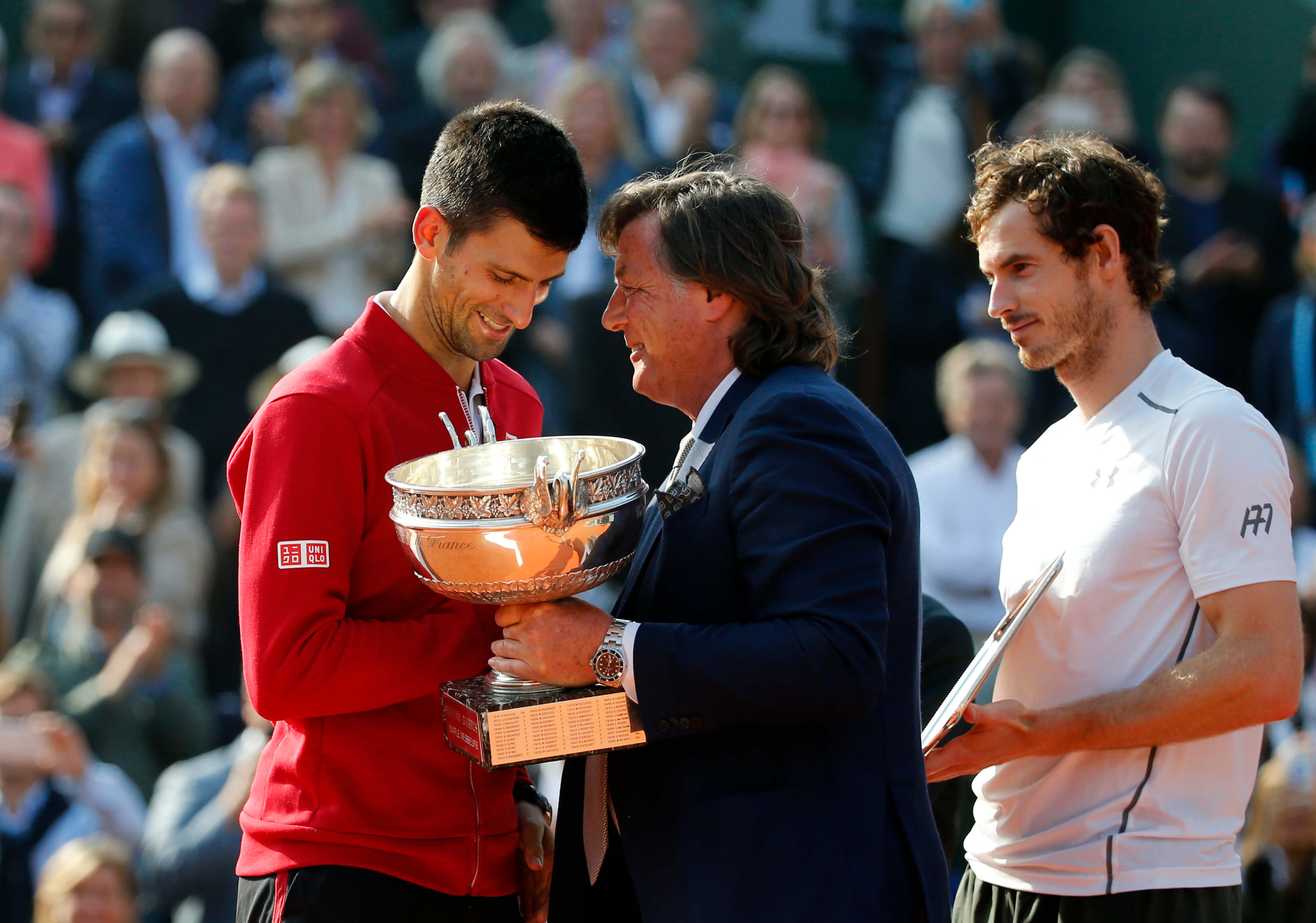 Image of Novak Djokovic receiving trophy after winning the French Open