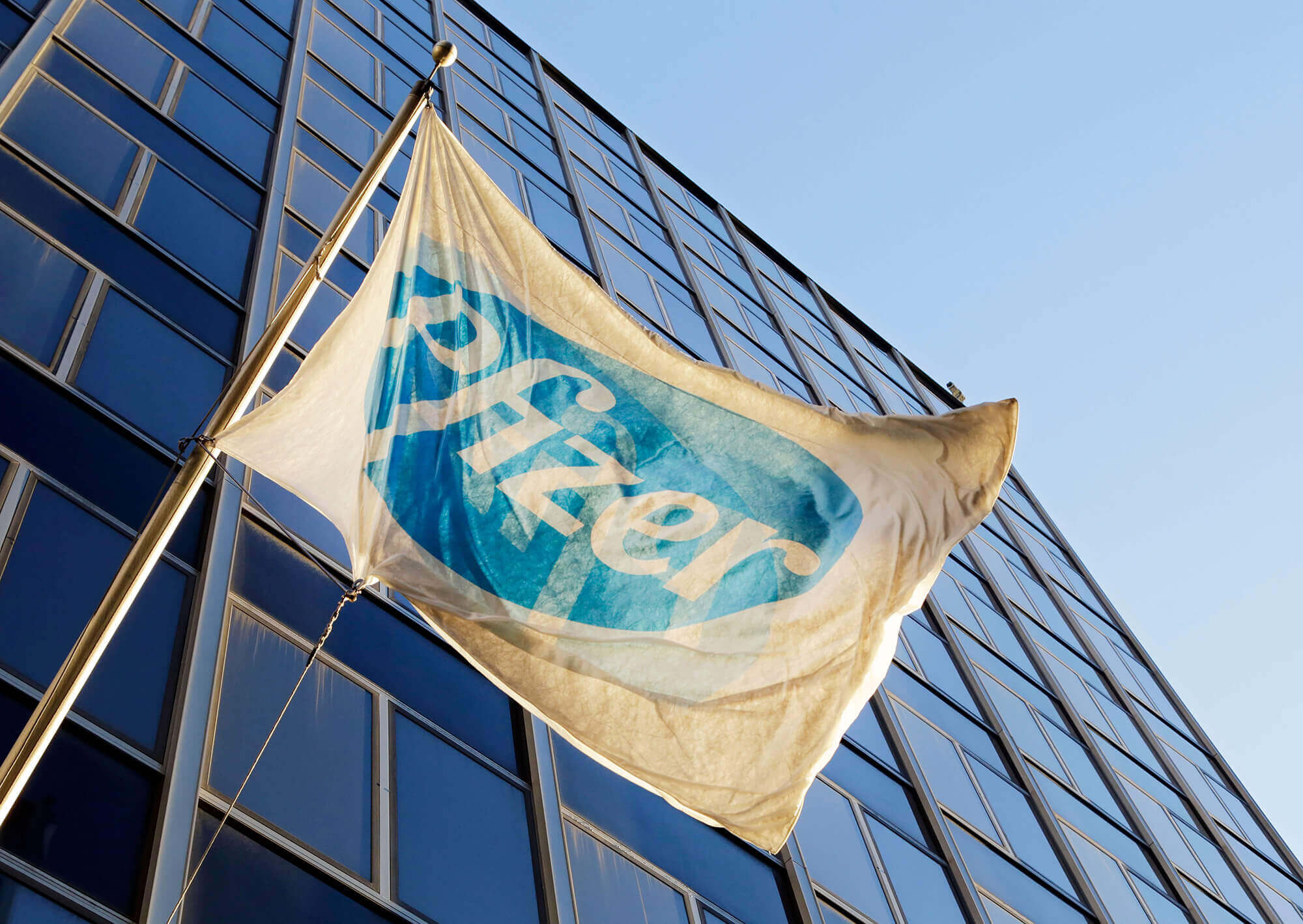 the Pfizer flag flies in front of world headquarters in New York