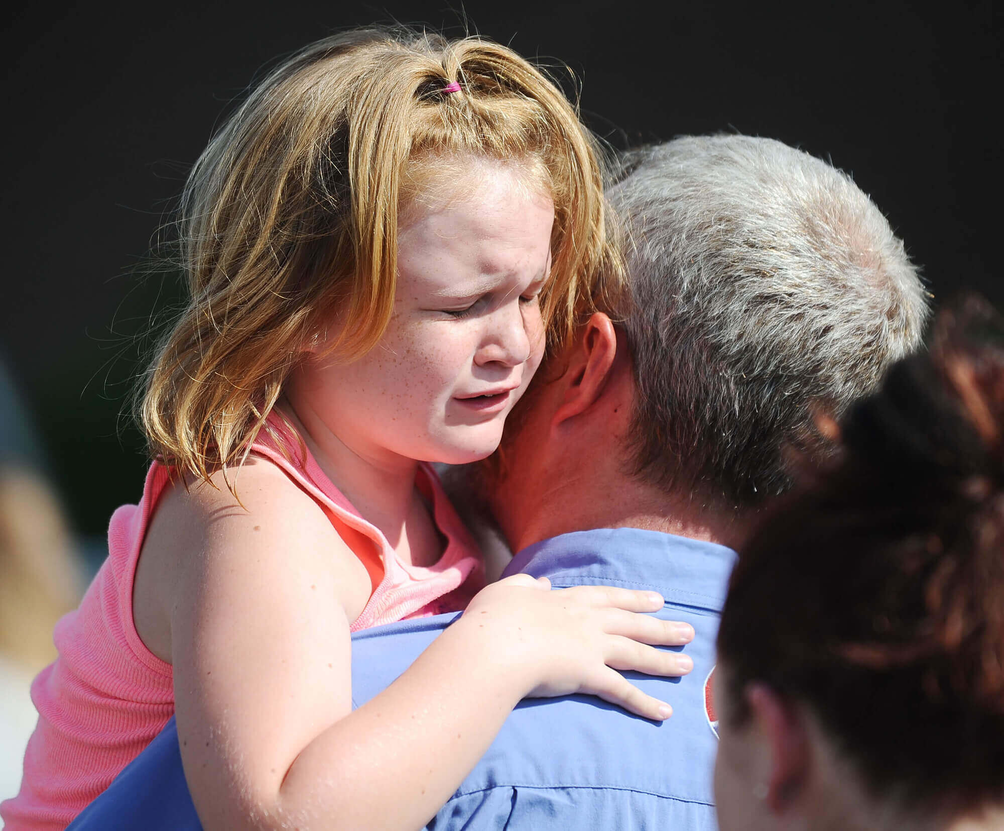 Image of child being reunited with father after school shooting